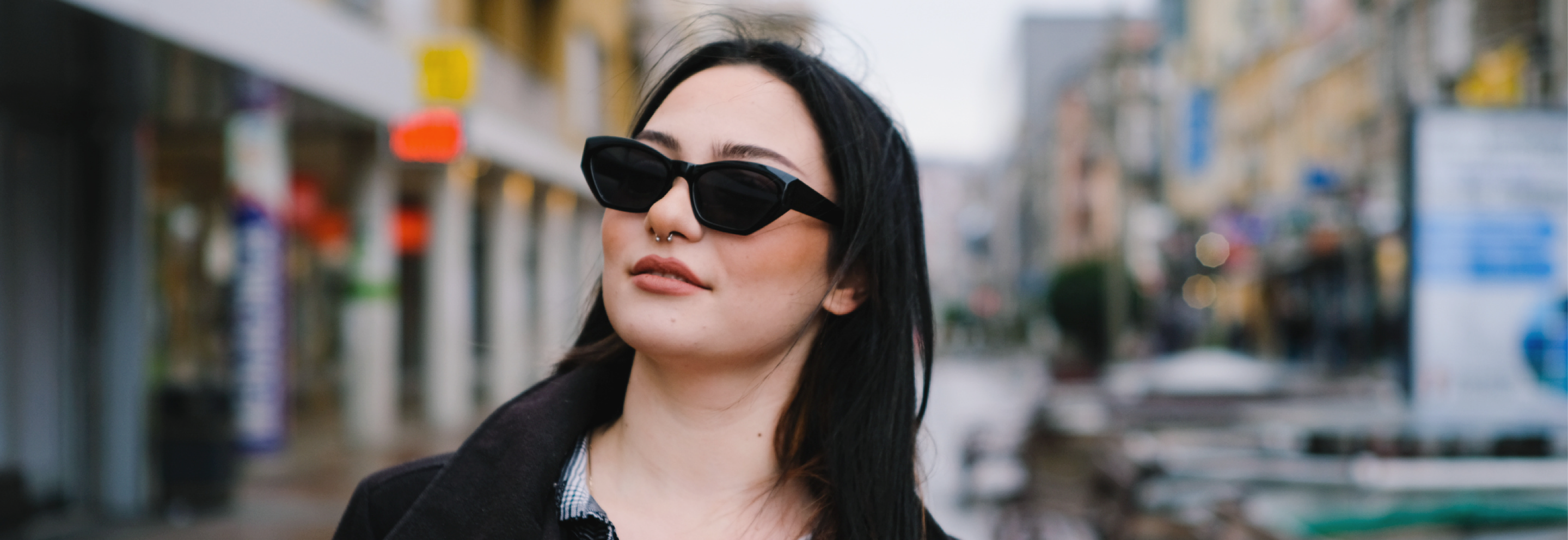 Lady wearing slim black sunglasses in high street